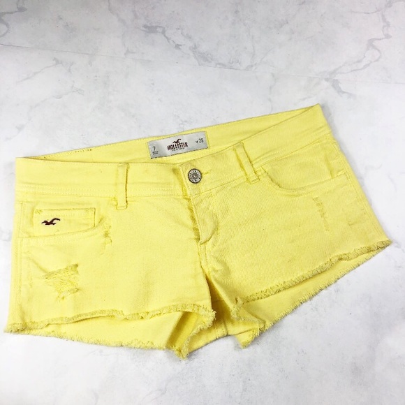 yellow distressed shorts